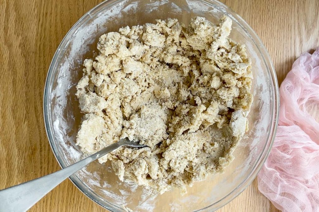 The crumbly cookie dough when it is ready to have the chocolate chips added to it.