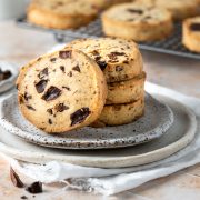 A stack of egg free chocolate chip cookies on a plate.