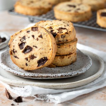 A stack of egg free chocolate chip cookies on a plate.