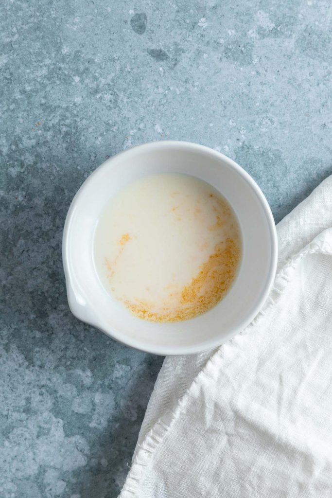 Milk and orange juice in a small bowl.