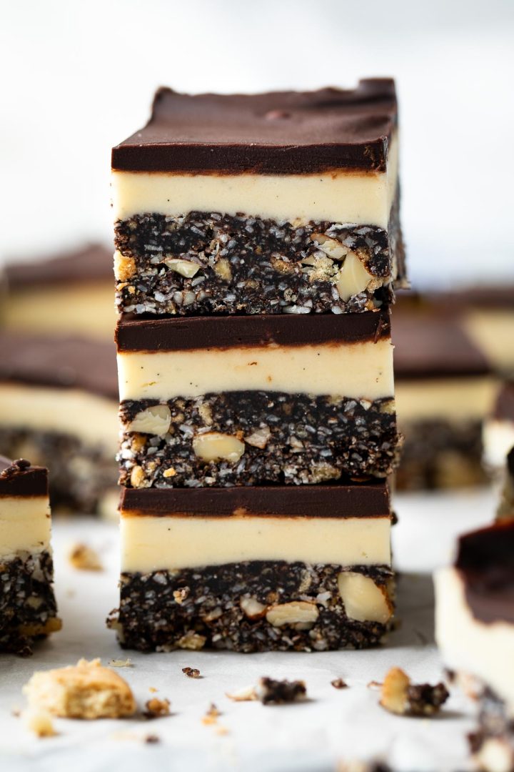 close up of a stack of 3 Nanaimo bars to show their layers.