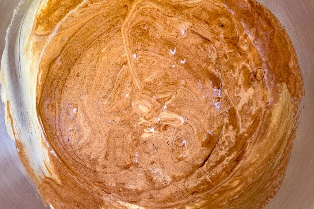 The melted chocolate mixture added to the whisked eggs.