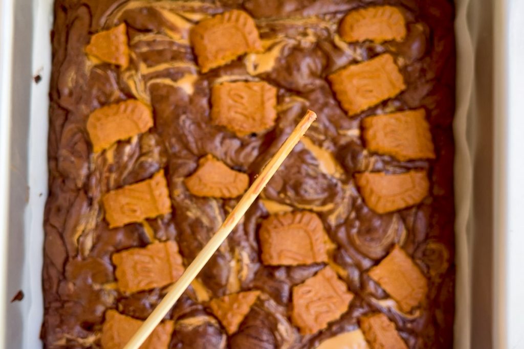 A skewer with only a few crumbs on it to show the brownie is cooked.