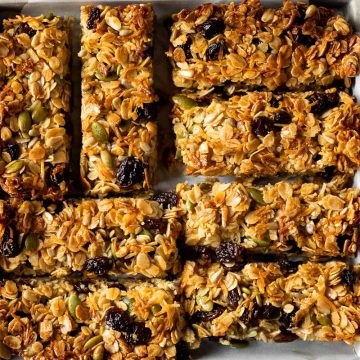 Muesli slice cut into bars and arranged on a square dish.