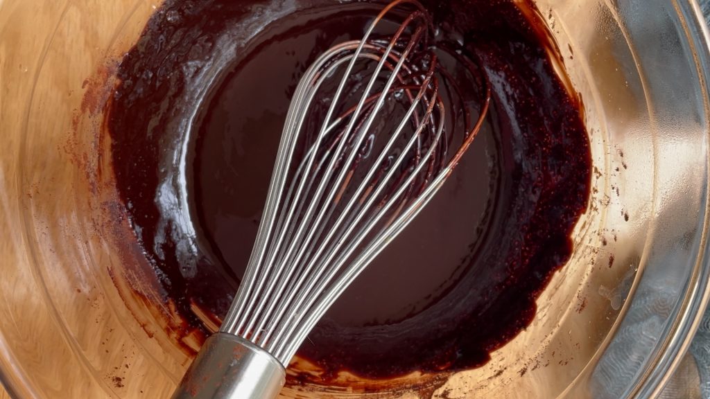 Melted butter and sugar mixed with cocoa powder.