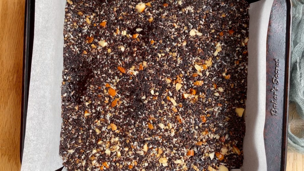 The Nanaimo base layer pressed into a lined square tin.