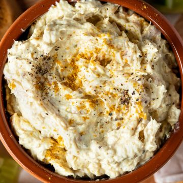 Close up of tuna dip in a terracotta bowl.
