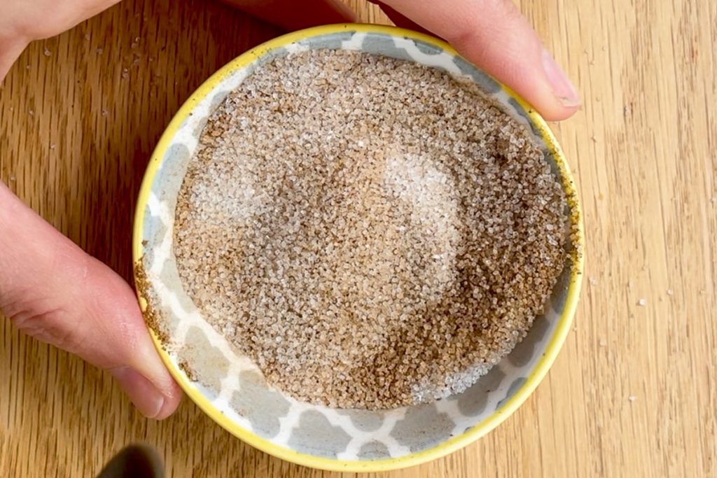 Ground sugar and cinnamon mixed together in a small bowl.