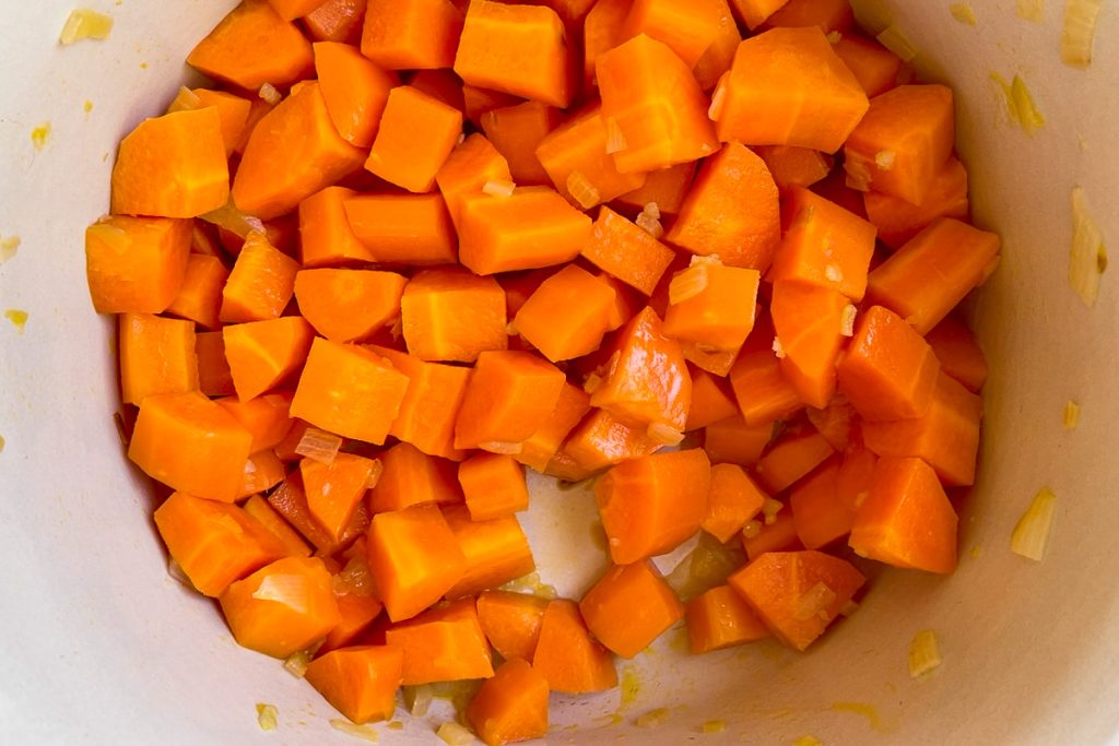 Chopped carrots in a pan once they are starting to soften.