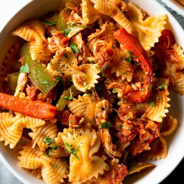 Close up of a white bowl filled with chicken and chorizo pasta.
