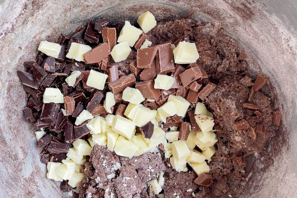 White chocolate, dark chocolate and milk chocolate chunks added to the cooie dough.