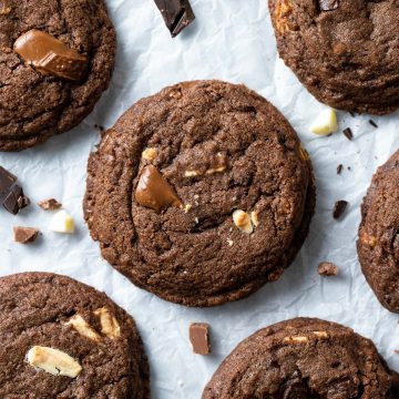 Triple chocolate chip cookies on white background.