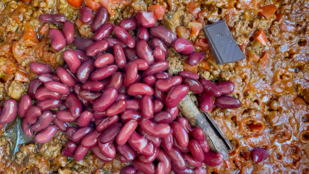 Kidney beans and dark chocolate added to the slow cooker.
