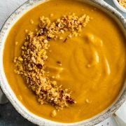 A bowl of winter root vegetable soup on a white napkin.
