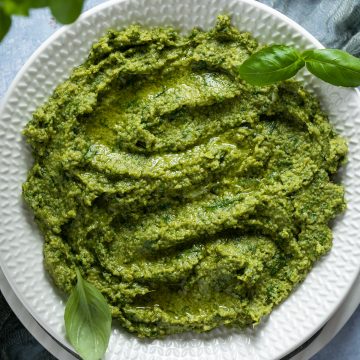 Basil pesto on a white plate.