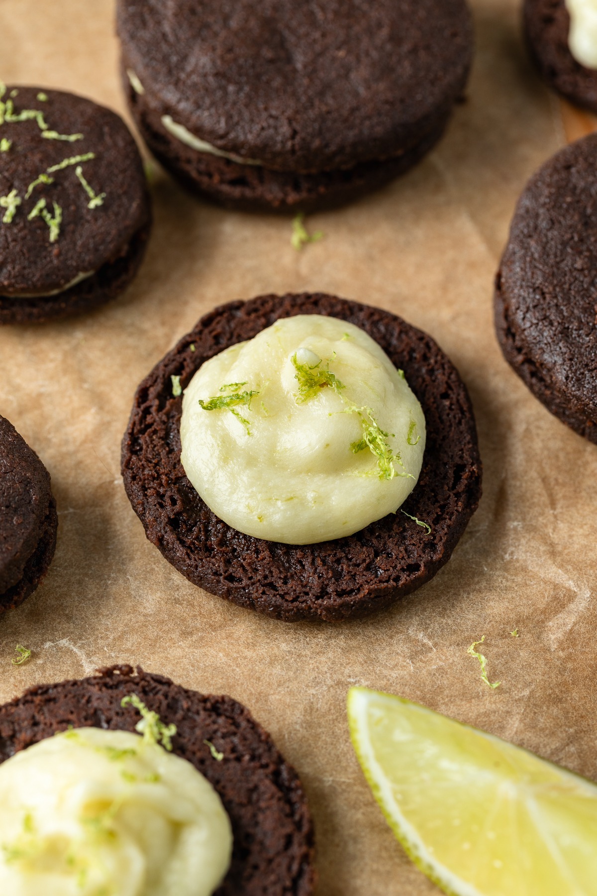 Close up of a chocolate cookie piped with lime buttercream.