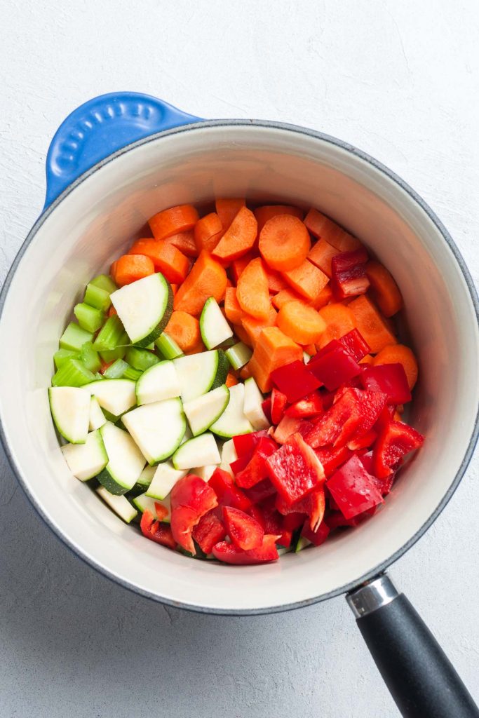 Chopped carrot, celery, zucchini, and red pepper added to the pan.