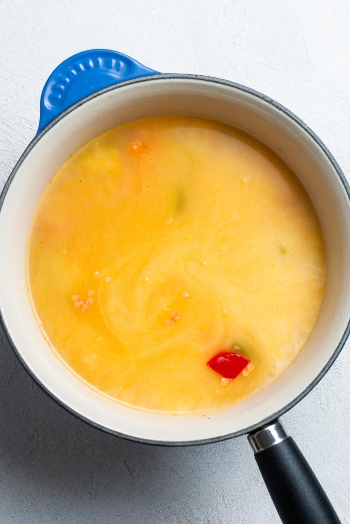 Stock added to the vegetables and lentils in the pan.