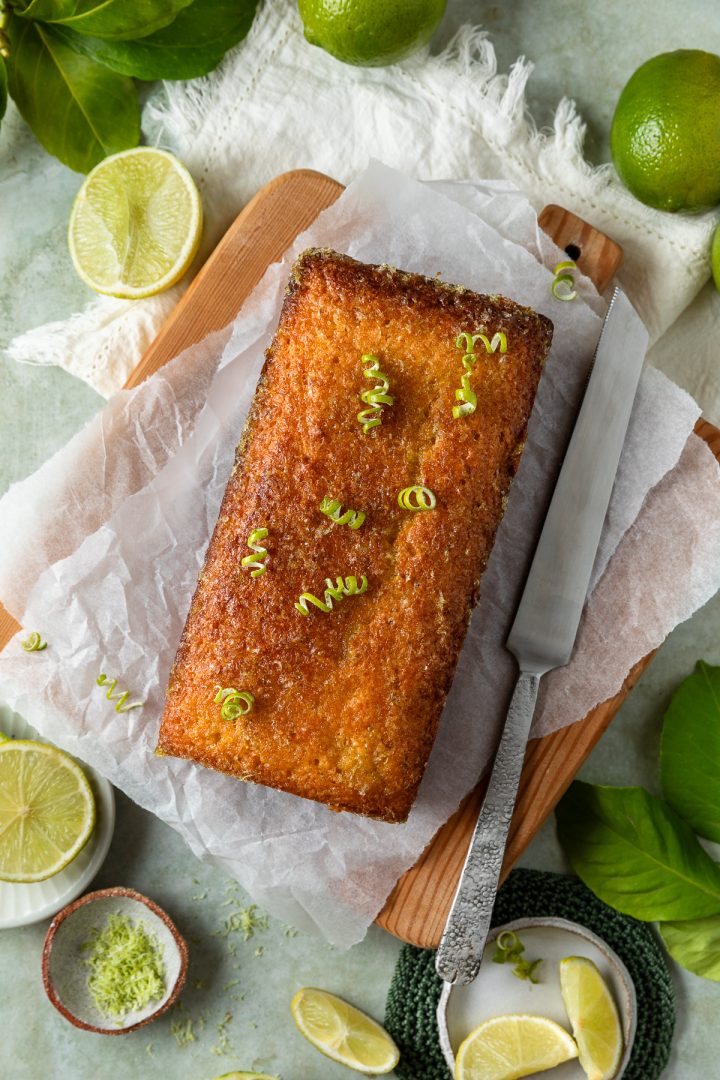 Baked lime cake with a cake knife to the right hand side of it.