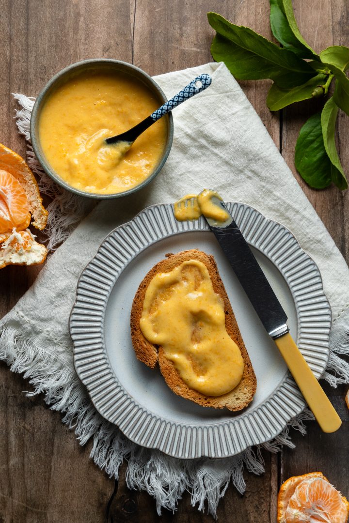Mandarin curd spread on a slice of toast.
