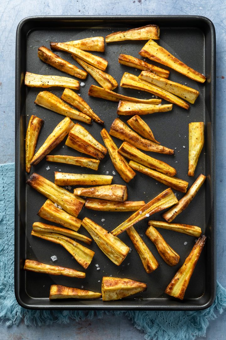 Roasted parsnips on a baking tray.