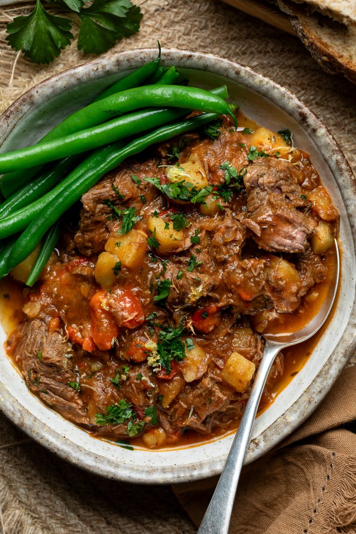 A serving of goulash with green beans.