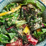 A bowl of cooked Japanese style silverbeet with sesame seeds sprinkled on top.