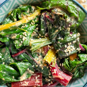 A bowl of cooked Japanese style silverbeet with sesame seeds sprinkled on top.