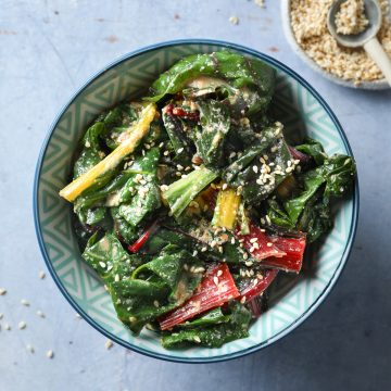 A bowl of miso silverbeet with extra sesame seeds in a dish in the upper right corner.