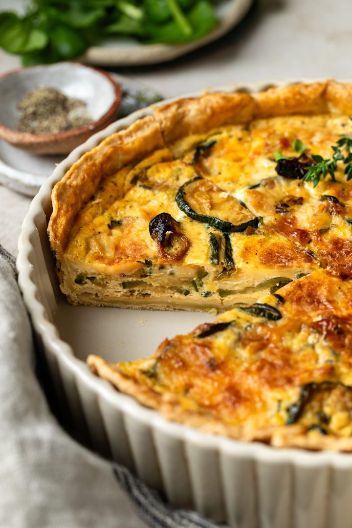Side view of the cut quiche to show the filling.