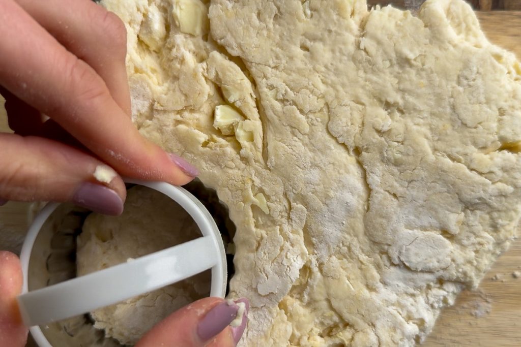 The dough being cut with a scone cutter.