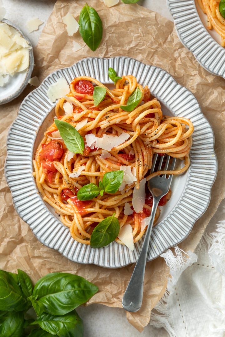 Close up of a plate of spaghetti in tomato sauce.