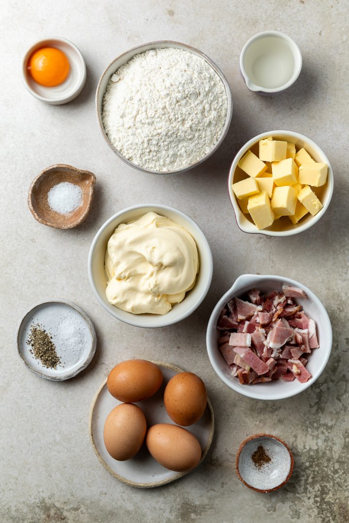 Ingredients needed to make the quiche recipe weighed out and placed in individual bowls.