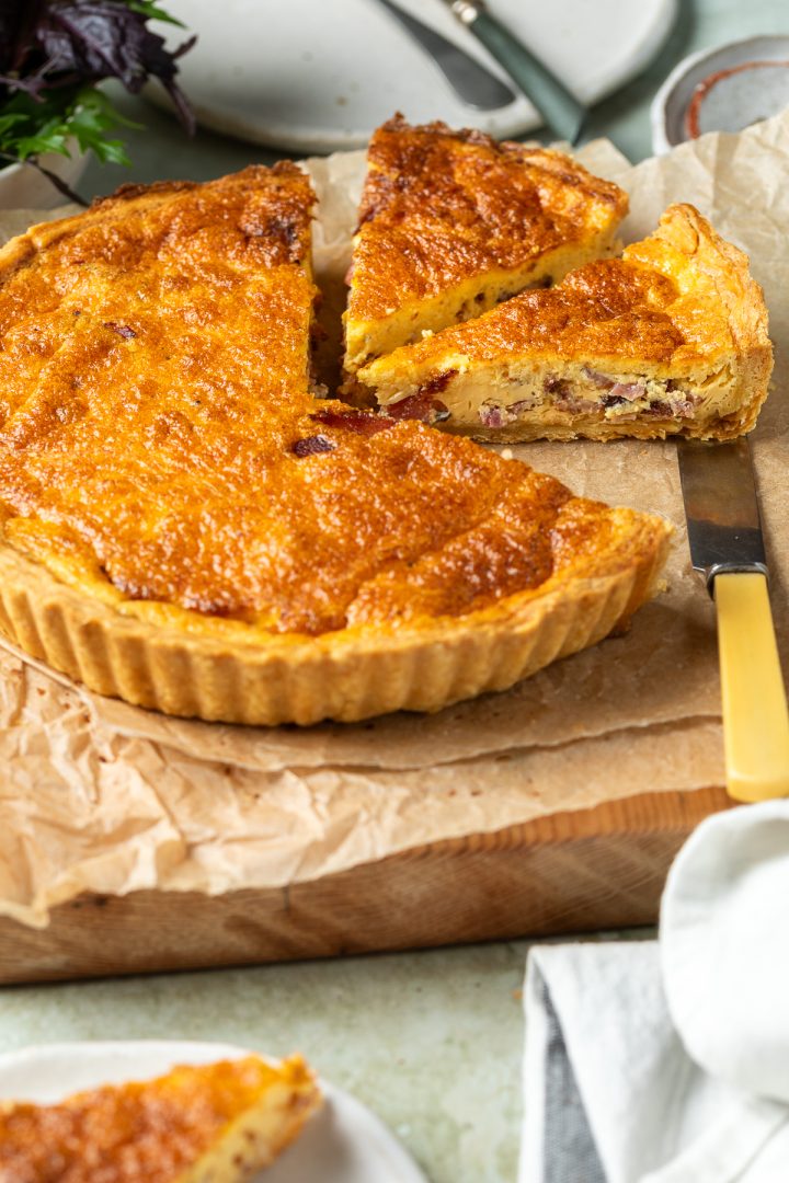 The quiche lorraine cut into slices to show the bacon filling.