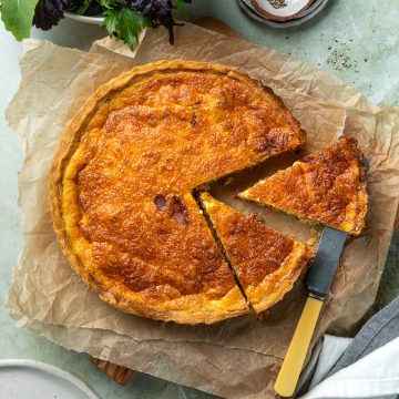 Quiche Lorraine with a couple of slices cut out of it.