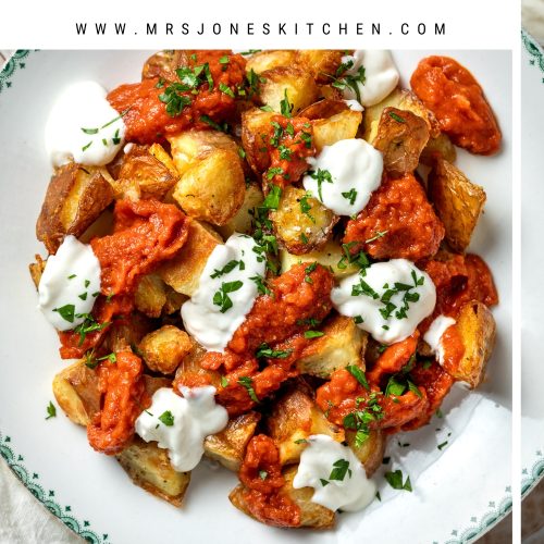 A plate of patatas bravas with text overlay to create a pin for Pinterest.