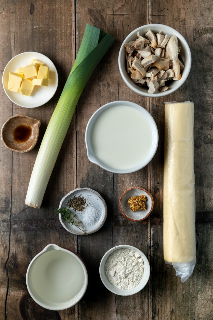 The ingredients needed to make the pie recipe weighed out and placed individually on a wooden backdrop.