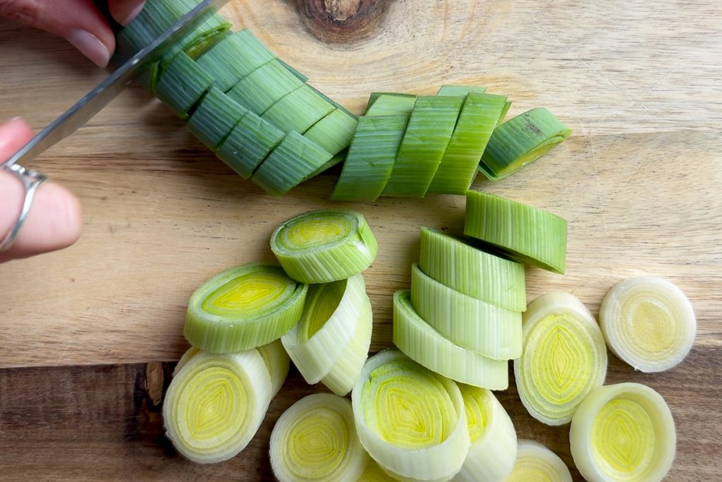 Chopping a leek into slices.