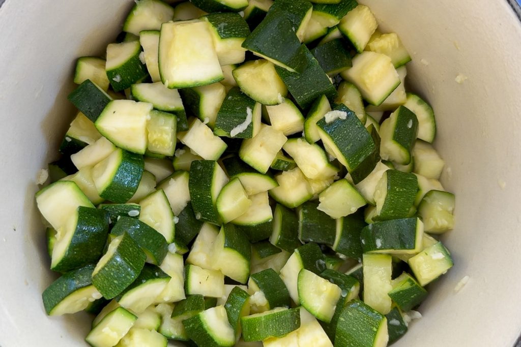 The cooked courgettes and garlic in the saucepan.