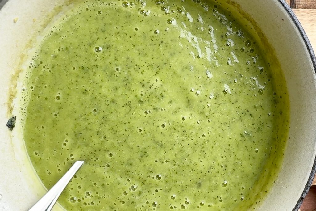 The blended courgette soup in a pan.