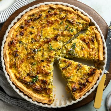 Flammiche (French Leek Tart) with 3 slices cut out of it.
