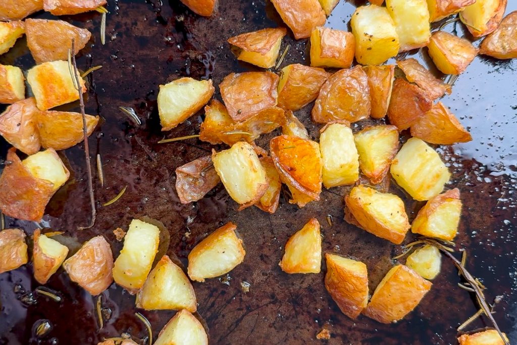 The roasted potatoes on the baking tin, ready to plate up.