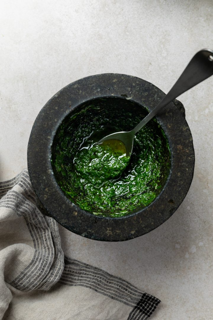 Freshly made basil pistou in a pestle and mortar.