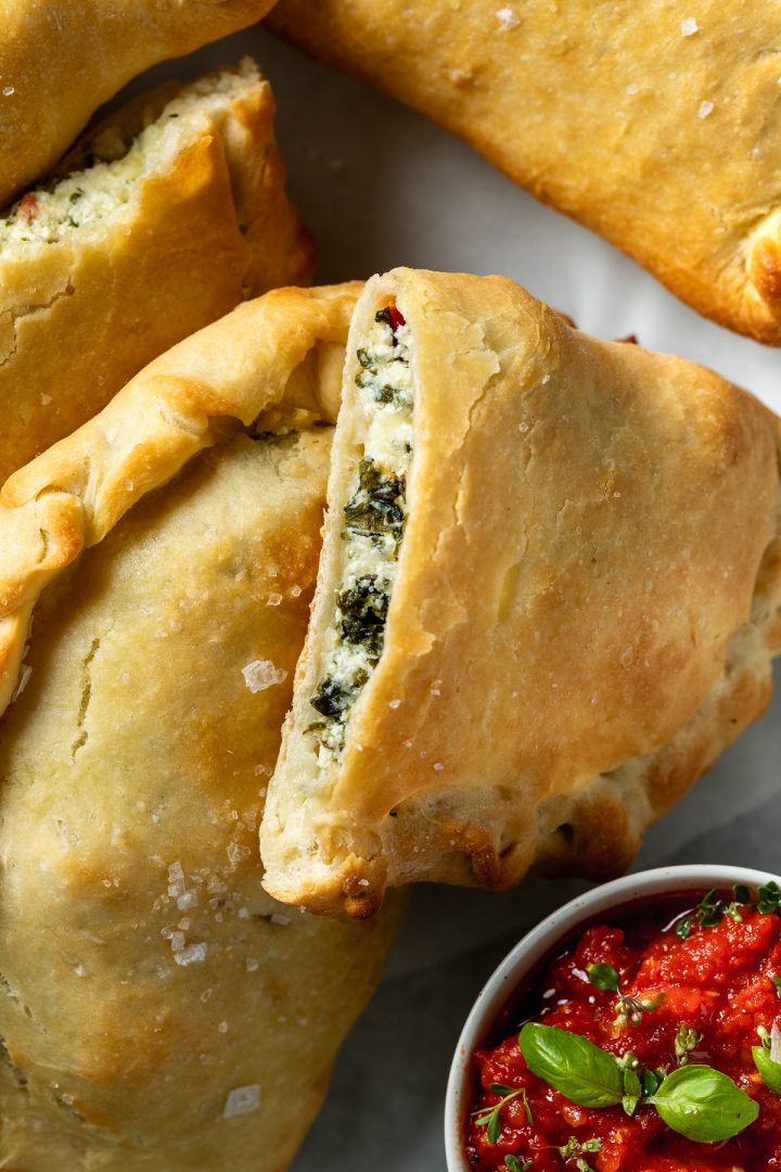 A calzone cut in half to show the filling.
