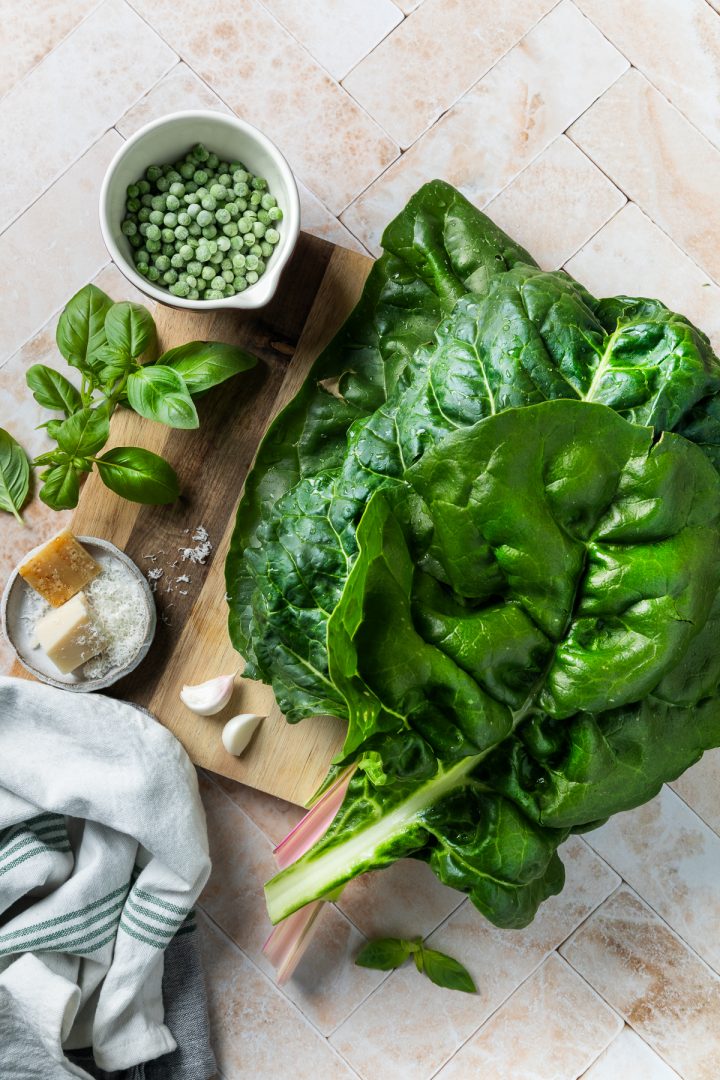 Ingredients needed to make the soup on a wooden chopping board.