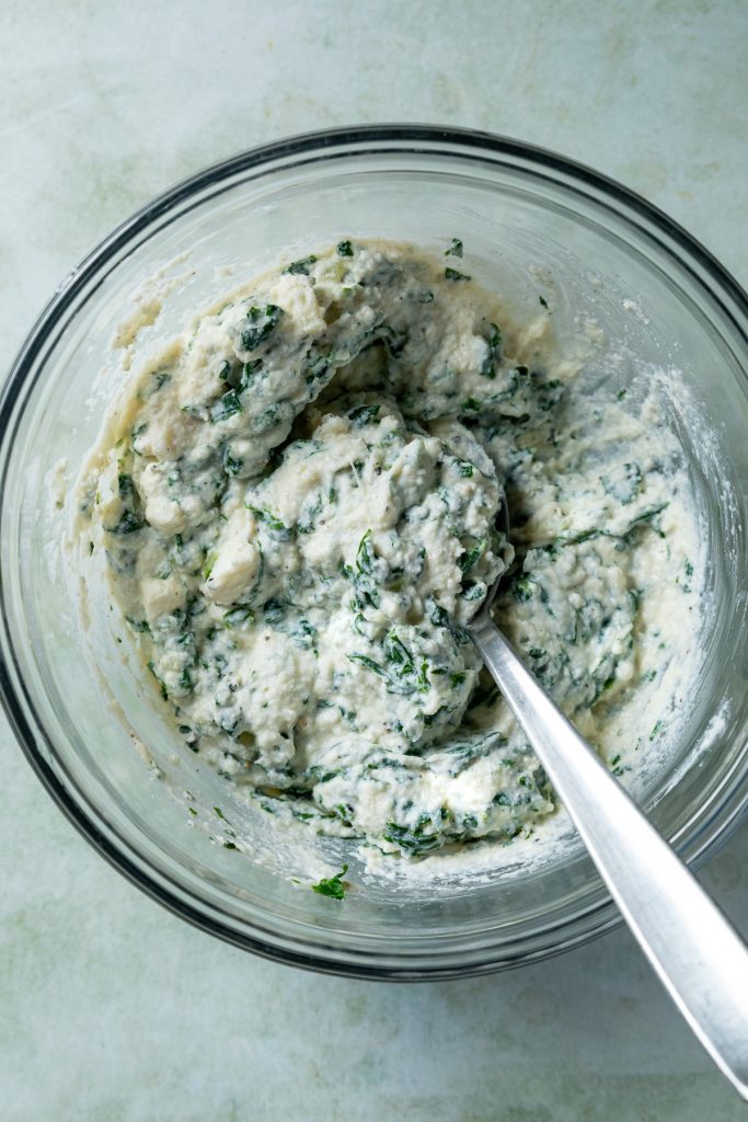 The silverbeet and ricotta filling mixed in a glass bowl.