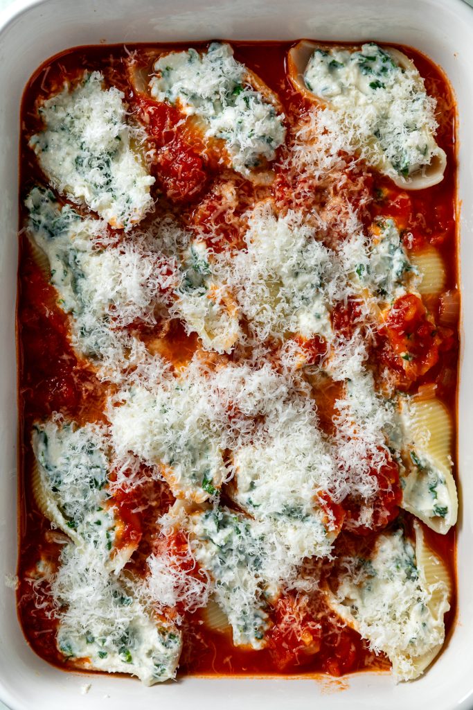The stuffed pasta shells sprinkled with parmesan, ready to go in the oven.