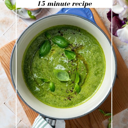 A blue saucepan of silverbeet soup sprinkled with fresh basil leaves, with text overlay to create a pin for Pinterest.