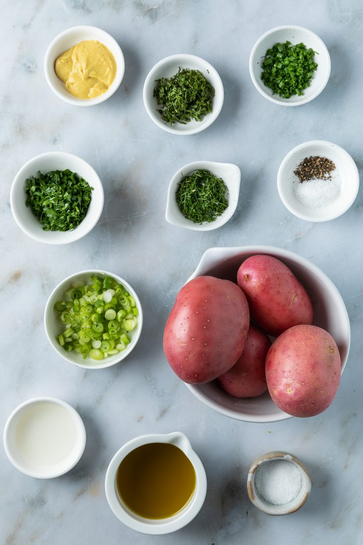 Ingredients for the potato salad recipe weighed out and placed in individual bowls.
