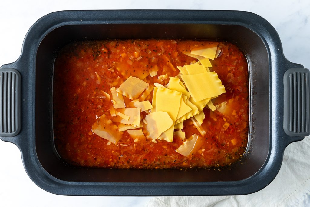 Broken up dried lasagna sheets added to the slow cooker soup.